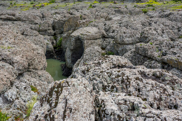 The green water of Arda river that slowly flows between the volcanic rocks of Sheytan Dere, or Devil Canyon, Southern Bulgaria