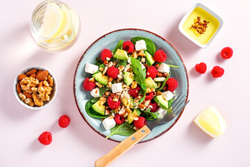 Light summer salad with raspberry, walnuts, avocado and cheese