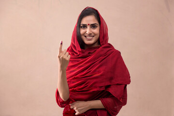 Portrait of a woman standing with voters mark. - obrazy, fototapety, plakaty