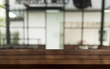 Empty wooden table top with lights bokeh on blur restaurant background.
