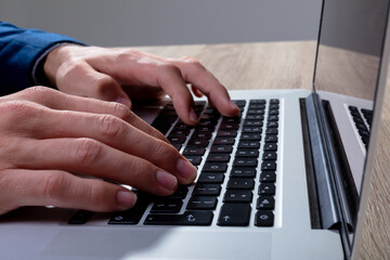 Midsection of caucasian businessman typing on keyboard, isolated on grey background