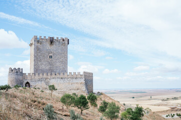 Fototapeta na wymiar Tiedra Castle built in the 11th century with blue sky with clouds. Image with copy space