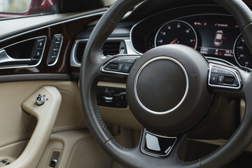 Close up of steering wheel. Car dashboard.
