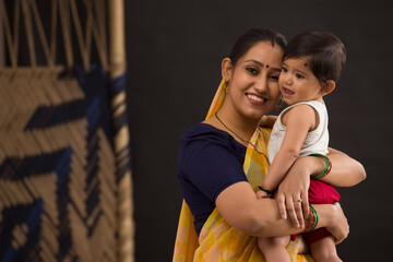 A woman holding her baby with affection.