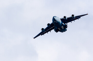 Fototapeta na wymiar RAF C17 on a training flight during the day with a clear blue sky