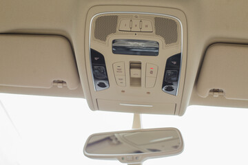 Car light panel on the top with buttons, air conditional and sun box.
