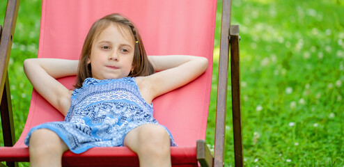 Funny portrait of attractive and very happy young girl without front teeth relaxing outdoors on nature. Sommer holiday concept. Copy space for text or design.