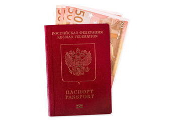 A red Russian passport for travelling and going abroad with a bunch of euros banknotes inside, isolated.