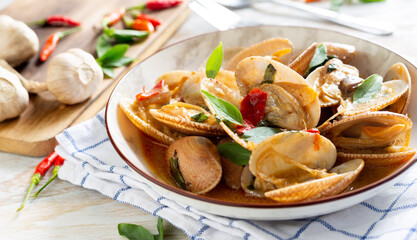 Stir-fried clams with chilli paste on the table