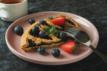 Concept of delicious food with blueberry pie on black smokey background