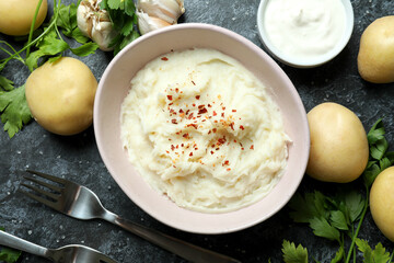 Concept of tasty eating with mashed potatoes on black smokey table