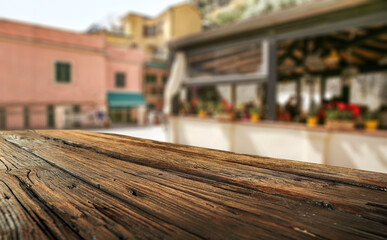 Fototapeta na wymiar Summer background of wooden desk and landscape of Italy 