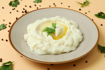 Plate of mashed potatoes and spices on beige background
