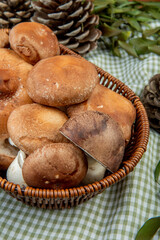 side view of fresh mushrooms in a wicker basket on rustic background