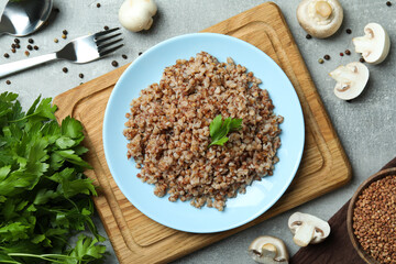 Concept of tasty eating with buckwheat on gray textured table