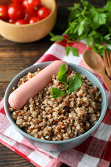 Concept of tasty eating with buckwheat on wooden table