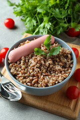 Concept of tasty eating with buckwheat on gray table