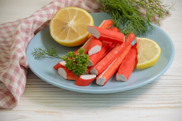 crab sticks, parsley on a wooden background
