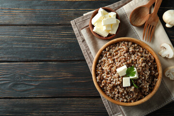 Concept of tasty eating with buckwheat on wooden table