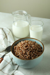 Concept of tasty eating with buckwheat on white textured table