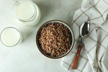 Concept of tasty eating with buckwheat on white textured table