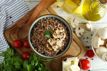 Concept of tasty eating with buckwheat on wooden table