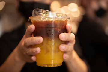 Coffee iced americano mix with orange juice in cafe