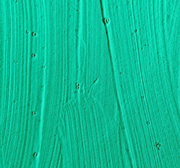 Green paint strokes. Stained   painted wall surface . rough plaster texture. sloppy bumpy staining,...