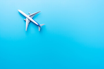 Naklejka na ściany i meble Top view of model airplane isolated on blue