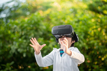 Child With Virtual Reality Headset Touching Outdoors