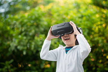 Child With Virtual Reality Headset Touching Outdoors