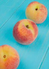 side view of fresh ripe peaches isolated on blue background