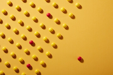 Yellow Chocolate candies on yellow Colored paper background