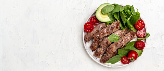 Bacon wrapped minced meat with spinach, avocado and cherry tomato, Healthy fats, clean eating for weight loss. Long banner format. top view