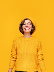 Cheerful woman in vivid yellow clothes