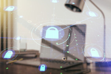 Double exposure of creative lock hologram with chip on laptop background. Information security concept