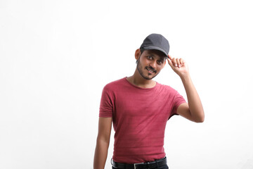 Young indian delivery boy showing expression over white background.