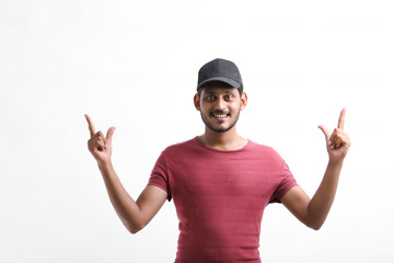 Young indian delivery boy showing expression over white background.