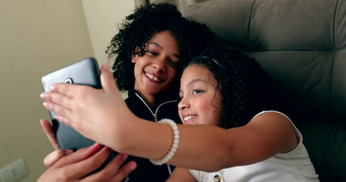Two little children taking selfie with device