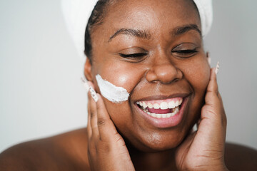 African young woman wearing skin mask - Beauty treatment  and body care concept - Main focus on...