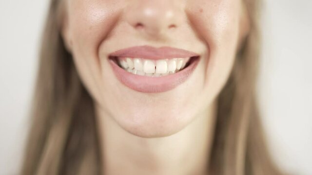 Close up of smiling teeth isolated. Detail of a smile woman. Young successful girl is smiling. Dentistry and teeth whitening concept