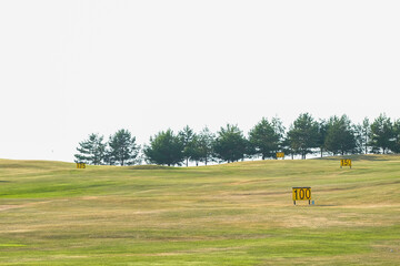 Golf course at sunset with signs
