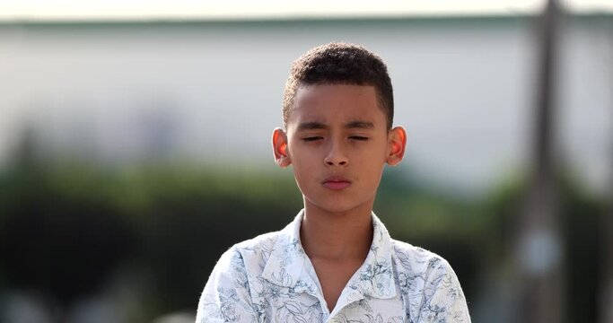 Upset child becoming serious changing emotion, distraught kid
