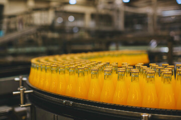 Beverage factory interior. Conveyor flowing with bottles for juice