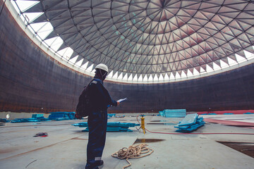 Male worker file record visual inspection tank into the confined space