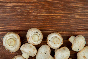 top view of fresh mushrooms isolated on rustic wooden background with copy space
