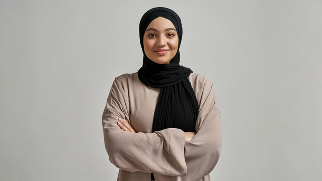 Portrait of smiling young arabian girl in black hijab