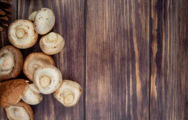 top view of fresh mushrooms isolated on wooden rustic background with copy space