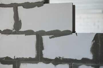 The process of building an apartment. Large concrete blocks. The white bricks are held together...