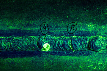 Round indication steel butt weld  green contrast of magnetic filed fluorescent test